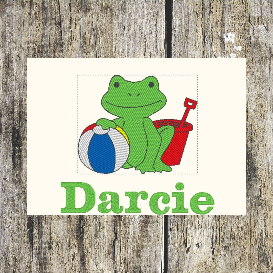 This fabulous frog is ready to go to the beach with their bucket and ball, perfect design for a personalised towel for beach days and even more fabulous when personalised with a name and embroidered onto hand towels, bath towels, bath sheets and hooded towels to order at Coralie's Crafts & Gifts in Dorset