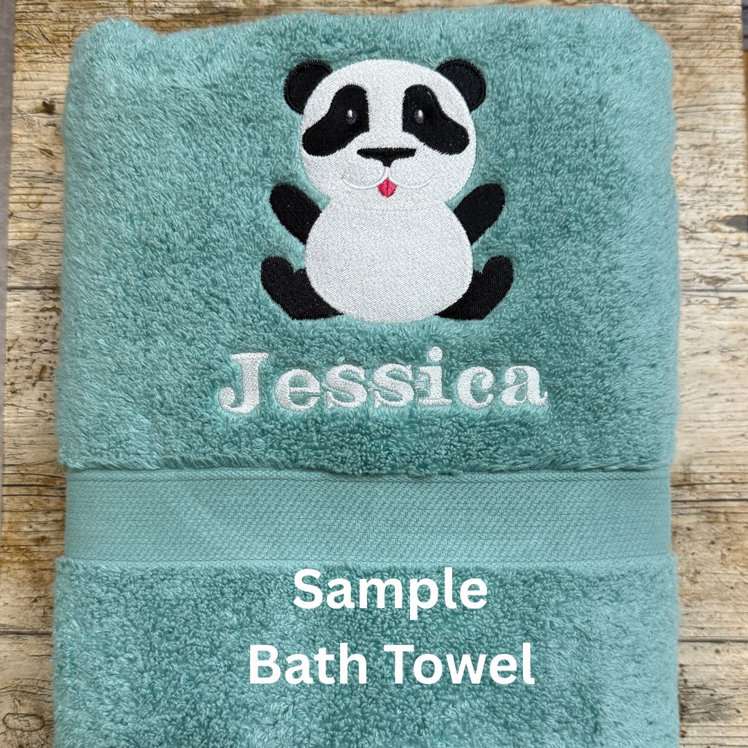 Teal bath towel with a panda design and the name 'Jessica' on a wooden surface.