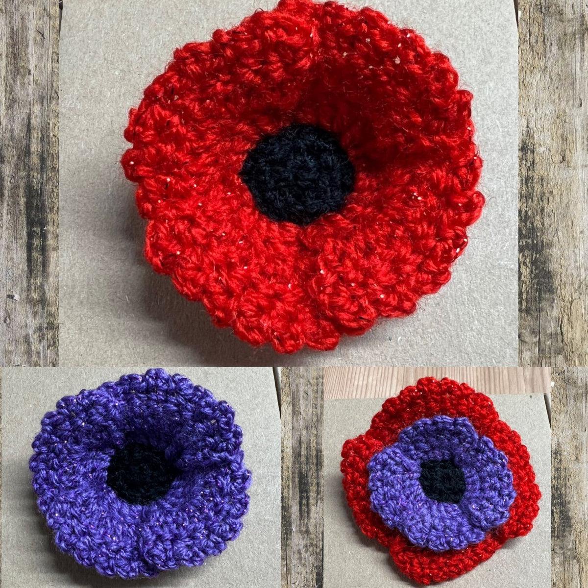 Poppy brooches for remembrance, one red, one purple and one red and purple on a wooden background