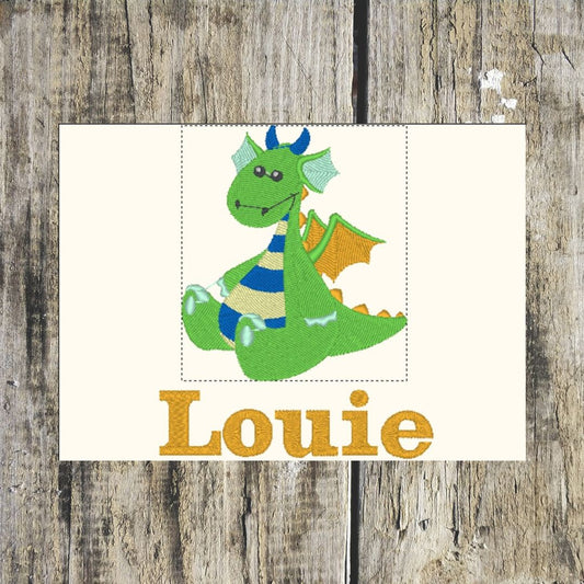 Embroidered patch of a green Baby dragon with blue accents and orange wings on a wooden background.