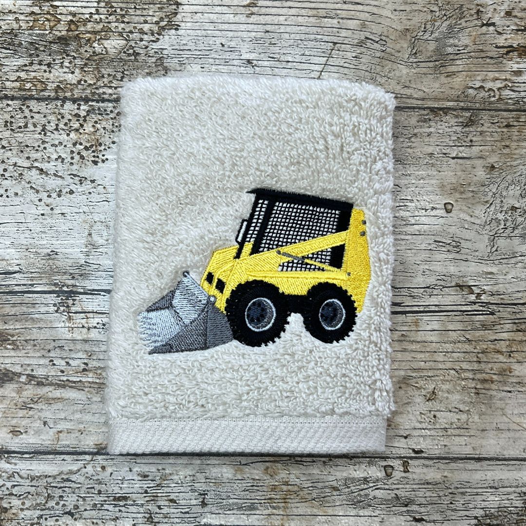 Fabulous Caged Digger Design embroidered onto a face cloth, placed on a wooden background, by Coralie's Crafts & Gifts