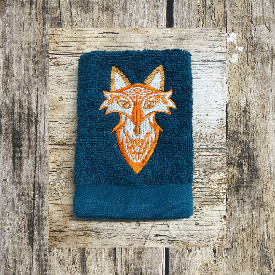 Lovely Bright orange Celtic fox design embroidered onto face cloths to order at Coralie's Crafts Gifts in Dorset.