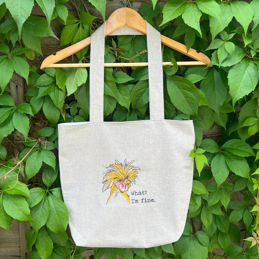 This beautiful handmade tote bag has a wonderful rather frazzled chicken design embroidered on the front with a quote saying "What? I'm fine." The bag is all handmade and fully lined inside with a pocket at the top.