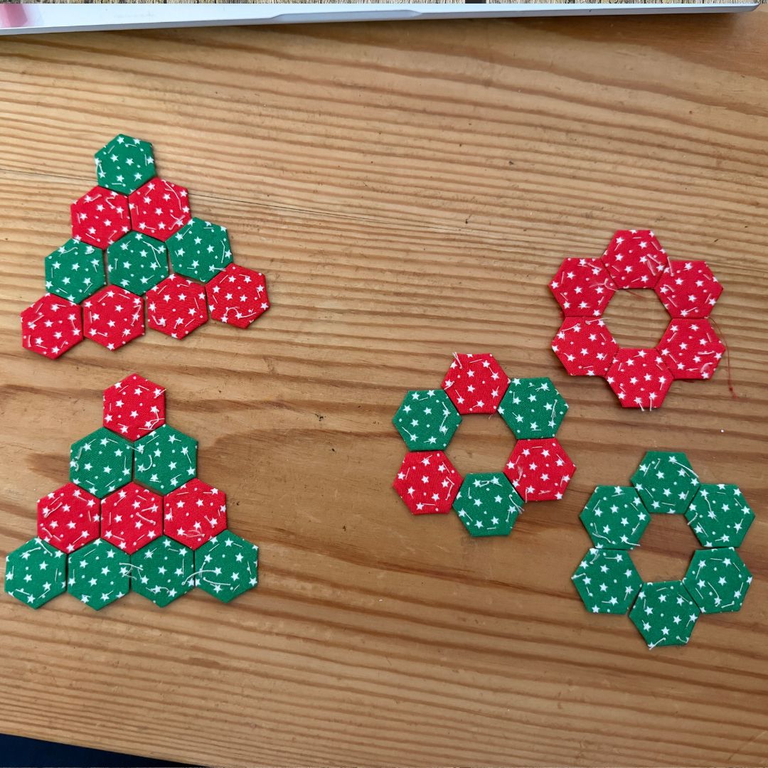 Hexagonal Christmas-themed decorations on a wooden surface