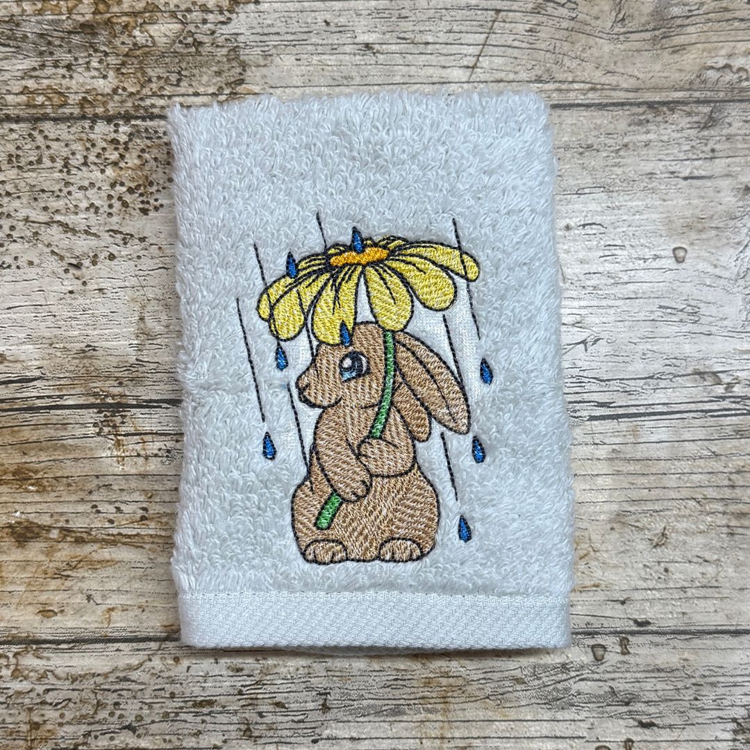 This rather cute adorable Bunny holding a flower to keep the rain off is just too cute and adorable, this embroidery design is embroidered onto facecloths to order by Coralie's Crafts & Gifts in Blandford Dorset. 