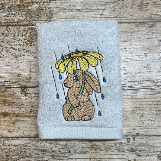 This rather cute adorable Bunny holding a flower to keep the rain off is just too cute and adorable, this embroidery design is embroidered onto facecloths to order by Coralie's Crafts & Gifts in Blandford Dorset. 