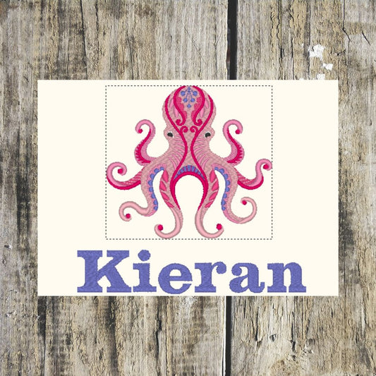 Funky Octopus design showed in a layout format, with the name Kieran underneath, to show what a towel would look like, on a wooden background. Design setup done by Coralie's Crafts & Gifts.