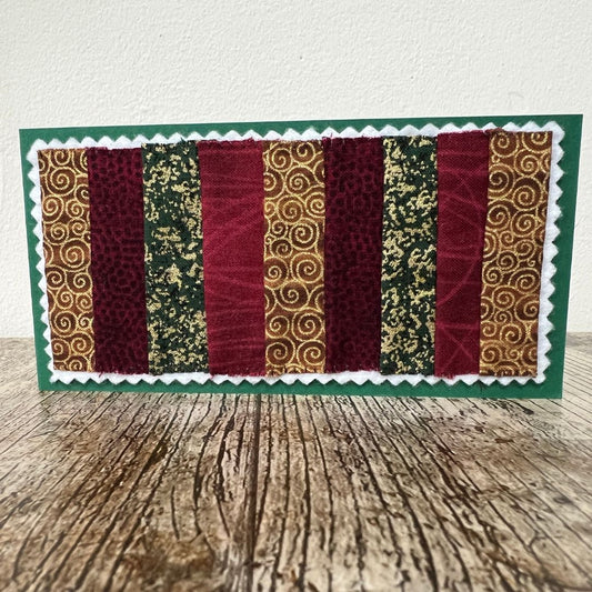 Decorative card with patterned Fabric stripes on a wooden surface