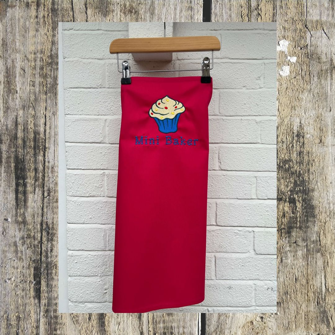 This wonderful red mini baker apron has a wonderful cupcake design on it, with added sprinkles and the wording Mini Baker on it