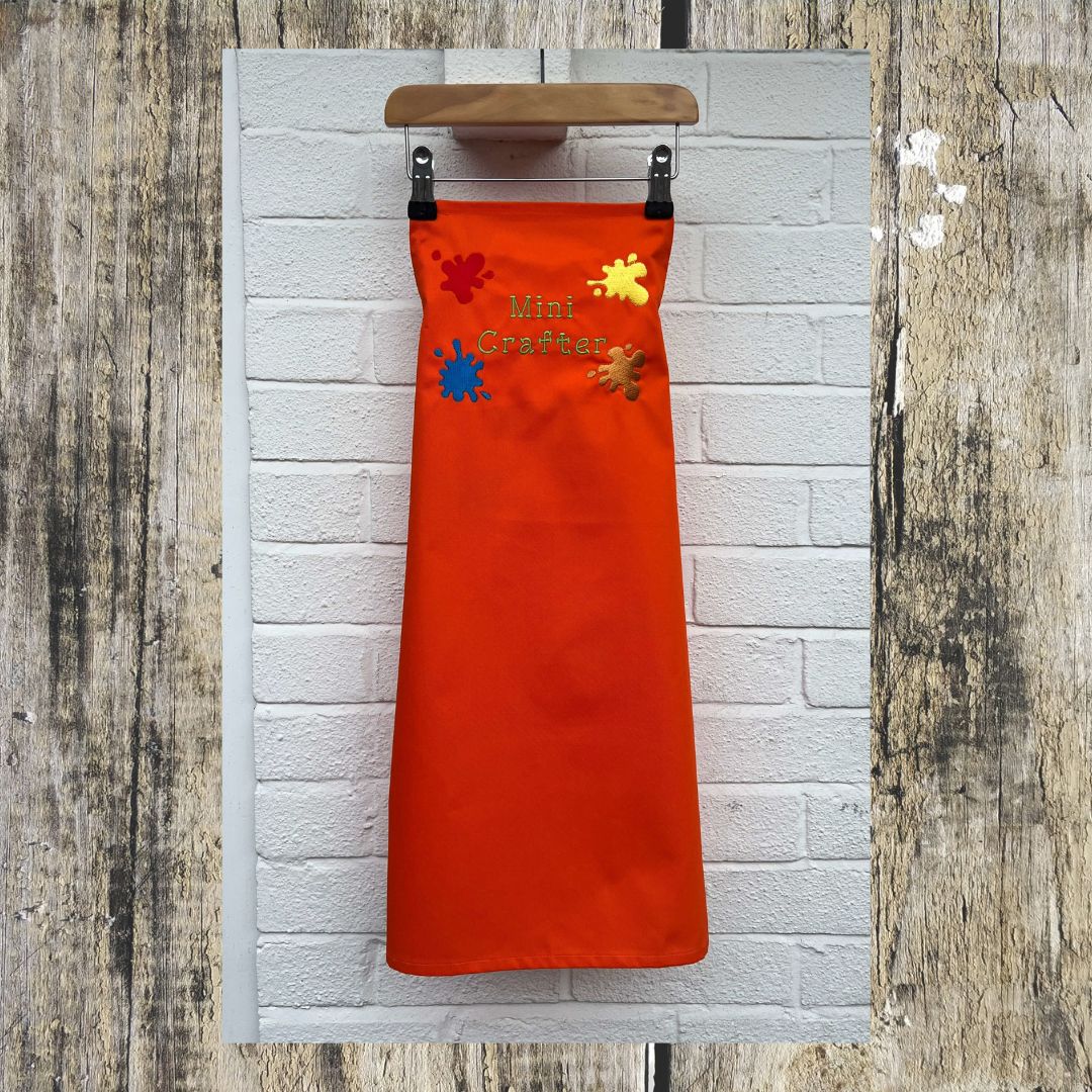 This wonderful orange Mini Crafter Apron has embroidered splodges of paint on it and the wording  Mini Crafter, Here is the full size of the apron,  all embroidered by Coralie at Coralie's Crafts & Gifts.