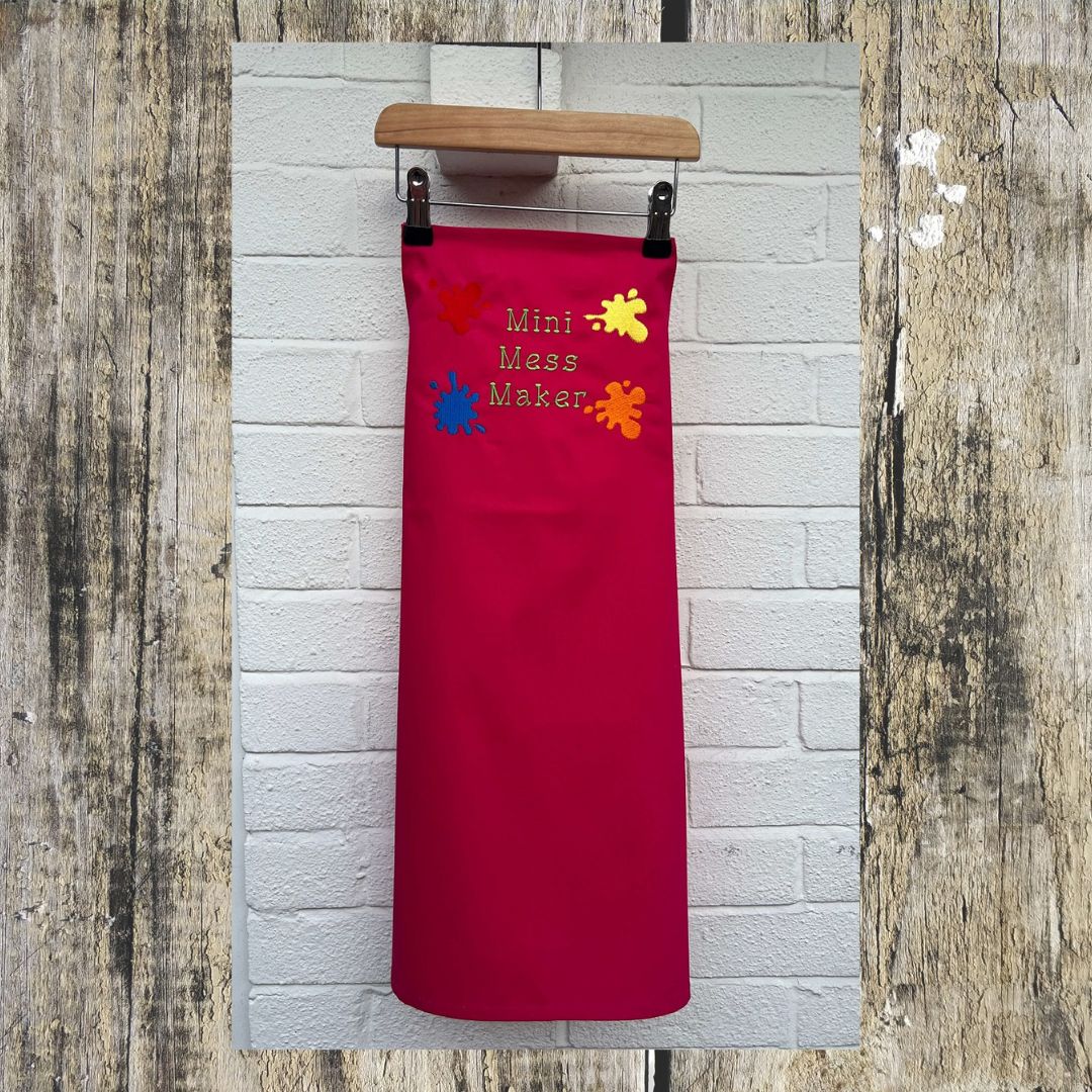 Full size picture of the pink apron, each apron has fully adjustable strap with a safety clip on. 
