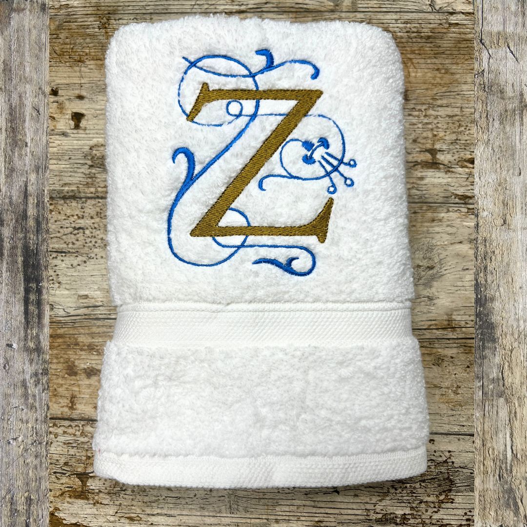 White towel with embroidered letter 'Z' on a wooden surface