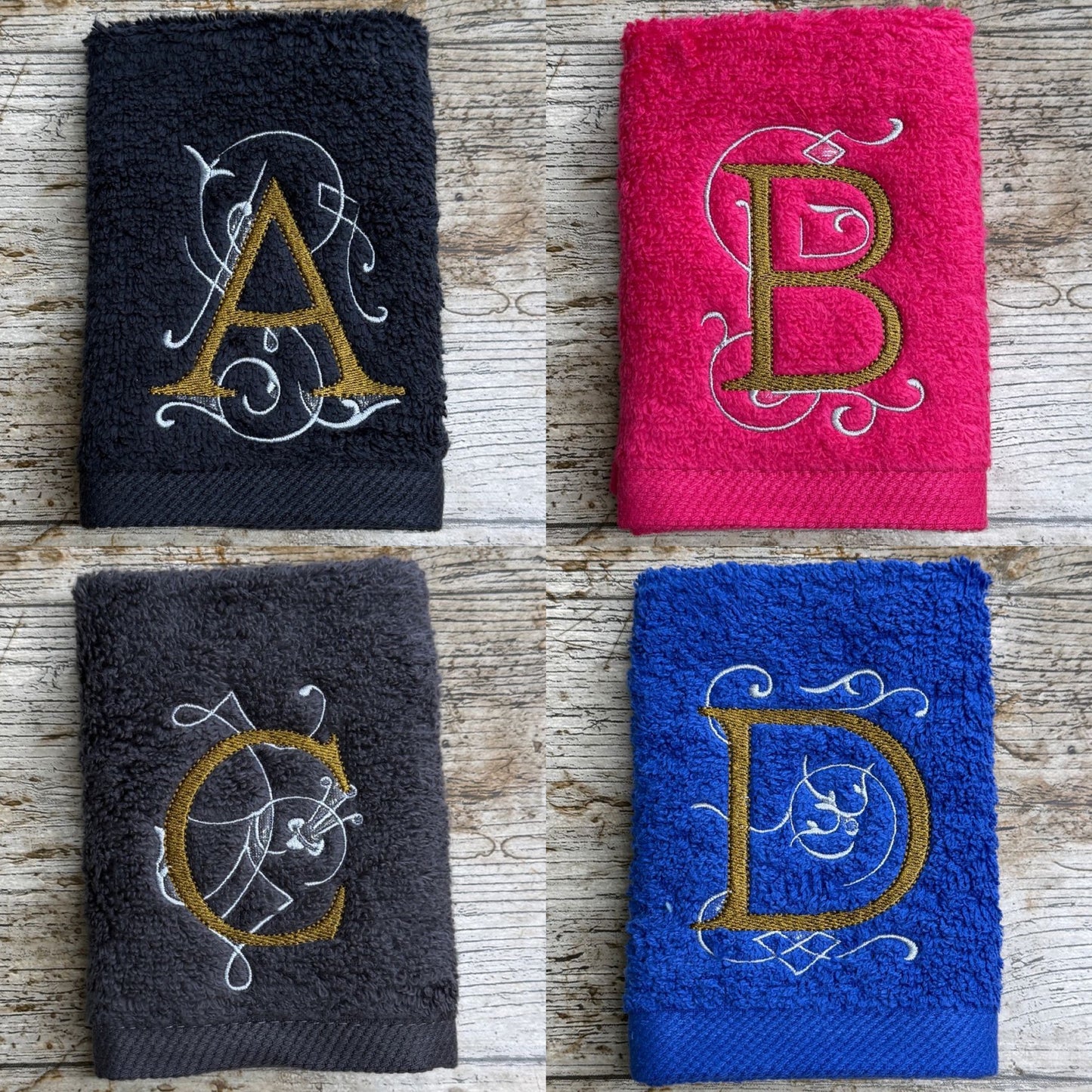 Four embroidered towels with monograms on a wooden surface