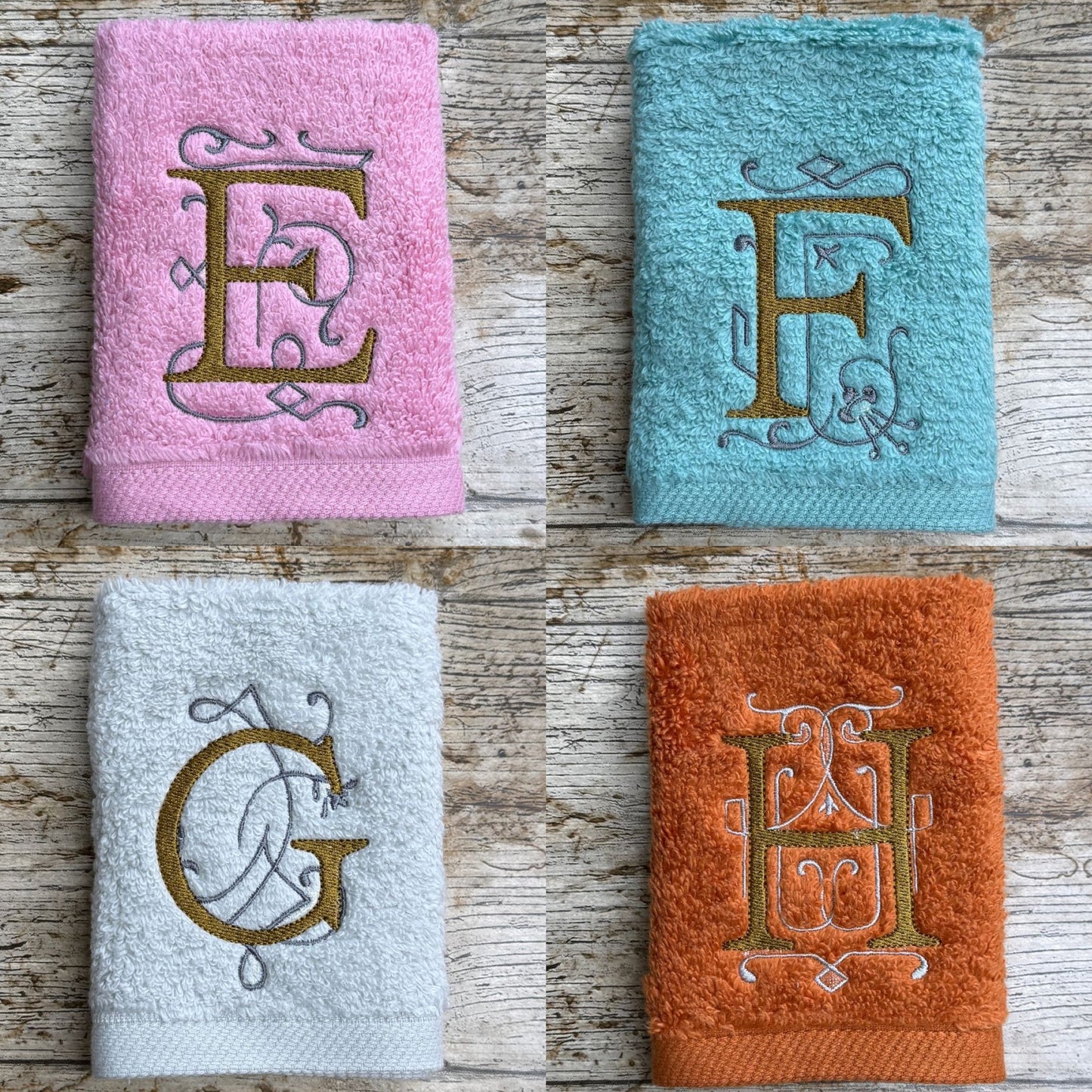 Four towels with embroidered letters on a wooden surface