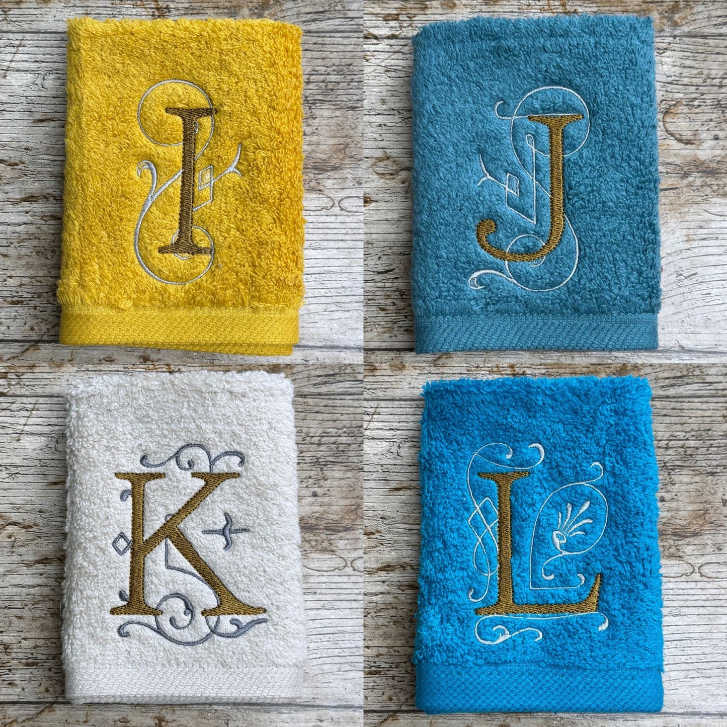 Four towels with embroidered letters on a wooden surface