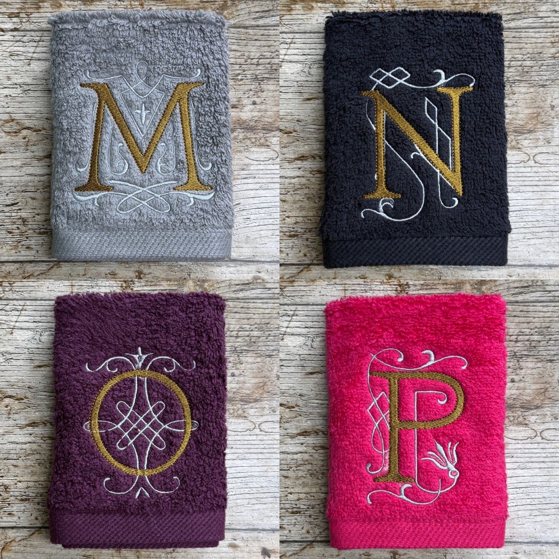 Four towels with embroidered letters 'M', 'N', 'O', and 'P' on a wooden surface.