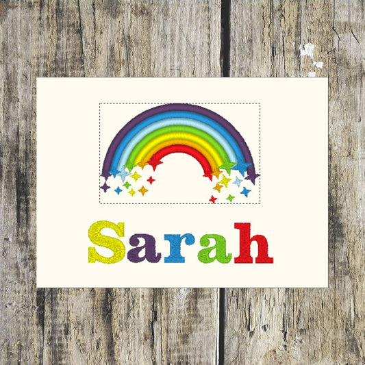 Colourful rainbow with stars and the name 'Sarah' personalised layout on a wooden background