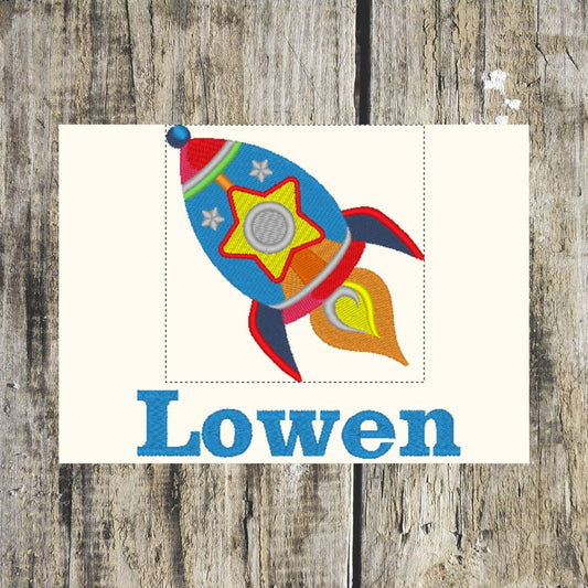 Colorful rocket design with 'Lowen' text on a wooden background